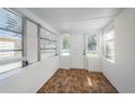 Enclosed front porch area with tile floors, white walls, and windows that allow natural light to enter the space at 1611 Canterbury N Rd, St Petersburg, FL 33710