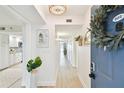 Bright and airy hallway with a view leading to the kitchen, decorated with wreaths and modern decor at 2 Adalia Ave # 602, Tampa, FL 33606