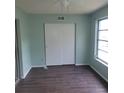 Bedroom features fresh paint, modern wood-look floors, closet, and natural light at 2043 Denmark St # 77, Clearwater, FL 33763