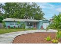 Charming home showcasing well-maintained landscaping, and a welcoming front entrance at 2405 Indigo Dr, Clearwater, FL 33763