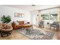 Cozy living room features stylish furniture, a patterned rug, and ample natural light from a large window at 2405 Indigo Dr, Clearwater, FL 33763