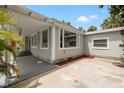 Side of the house with a covered patio and a large window offering ample natural light at 2835 Valencia S Way, St Petersburg, FL 33705