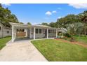 Street view of a well-maintained single-story home with covered parking and mature landscaping at 2835 Valencia S Way, St Petersburg, FL 33705
