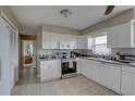 Bright kitchen featuring white cabinets, tile floors, stainless steel appliances, and plenty of natural light at 4308 5Th W Ave, Palmetto, FL 34221