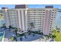 An aerial view showcases the building's facade, parking, landscaping, and inviting entrance at 4775 Cove Cir # 205, St Petersburg, FL 33708