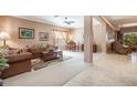 Comfortable living room with neutral tones, stylish furnishings, and an open layout to dining area at 6214 45Th E Ln, Bradenton, FL 34203