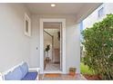 Inviting front entrance with a bench, decorative rug, and views of the staircase and hardwood floors at 6219 Voyagers Pl, Apollo Beach, FL 33572