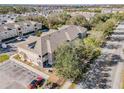 Aerial view of the property, showing the building and surrounding neighborhood with lush trees at 6414 Hollydale Pl # 101, Riverview, FL 33578