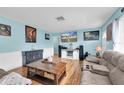 Comfortable living room featuring a large TV, plush sofas, and stylish decor at 701 63Rd S St, Gulfport, FL 33707