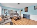 Cozy living room with hardwood floors, a plush sofa, and ample natural light at 701 63Rd S St, Gulfport, FL 33707