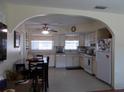 Bright kitchen featuring white cabinetry, a dining table, and modern appliances, perfect for cooking and entertaining at 7729 39Th N Ter, St Petersburg, FL 33709