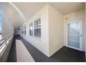 Hallway featuring carpeted floors and a textured wall. The entry door has glass at 7892 Sailboat Key S Blvd # 307, South Pasadena, FL 33707