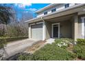 Townhome entrance showing covered porch and lush landscaping at 8004 Downpatrick Ct, Tampa, FL 33610