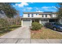 Exterior view of the townhome, showing the driveway and partial lawn at 8004 Downpatrick Ct, Tampa, FL 33610