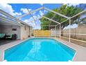 Gorgeous screened-in pool showcasing a private backyard oasis, perfect for relaxation and fun at 9040 Lunar Ln, Port Richey, FL 34668