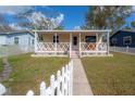 Adorable bungalow featuring a quaint front porch and well-kept lawn at 1053 56Th N Ave, St Petersburg, FL 33703