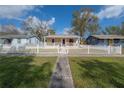 Charming home with a white picket fence and a well-manicured front yard at 1053 56Th N Ave, St Petersburg, FL 33703