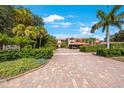 Long brick driveway leads to this building with well-maintained landscaping and a porte cochere at 1060 Pinellas Bayway S # 103, St Petersburg, FL 33715