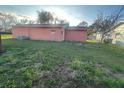 Fenced backyard with a small storage shed and some scattered trees at 1302 Highview Rd, Brandon, FL 33510