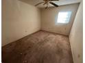 Bedroom featuring a ceiling fan, one window, and worn carpet at 1302 Highview Rd, Brandon, FL 33510