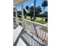 Inviting front porch showing white railings, sunny skies and neighborhood trees at 1321 W North B St, Tampa, FL 33606