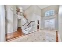 Elegant foyer with high ceilings, marble flooring, and a staircase leading to the second floor at 15901 Benton Ct, Tampa, FL 33647