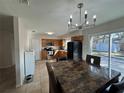 Open-concept kitchen and dining area with stainless steel appliances and modern lighting at 1919 E Noel St, Tampa, FL 33610