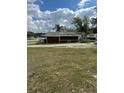 View of a utility shed on the property lot, backed by trees at 2102 W Ivy St, Tampa, FL 33607