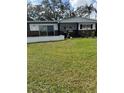 Charming single-story home with a front yard, showing the home's facade at 2102 W Ivy St, Tampa, FL 33607