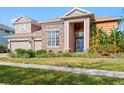 Attractive two-story house featuring a well-kept lawn, stone and wood accents, and a three-car garage at 21537 Draycott Way, Land O Lakes, FL 34637