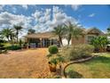 Well-manicured lawn and landscaping frame this charming single-story home at 2359 Emerald Lake Dr, Sun City Center, FL 33573