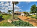 Mature landscaping and brick driveway enhance the curb appeal of this beautiful single-Gathering home at 2359 Emerald Lake Dr, Sun City Center, FL 33573