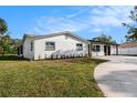 Charming single-story home with a brick facade, black trim, well-maintained lawn and long driveway at 239 Freeport Ne Ave, St Petersburg, FL 33702