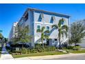 Beautiful blue three-story townhome boasts elegant shutters, well-maintained landscaping, and is conveniently located on a corner lot at 2510 W Cleveland St # 3, Tampa, FL 33609