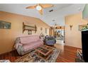 Inviting living room with wood floors, ceiling fan, and ample space for seating and relaxation at 2940 Bay View Dr, Safety Harbor, FL 34695