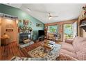 Cozy living room featuring a stone fireplace, wood floors, and access to the outdoor space at 2940 Bay View Dr, Safety Harbor, FL 34695