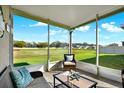 A screened in lanai with view of the lush green lawn at 3664 Zephyr Preserve Pl, Zephyrhills, FL 33541