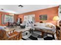 Spacious living room featuring modern decor and large windows, adjacent to the dining area at 6353 Spring Hill Dr, Spring Hill, FL 34606