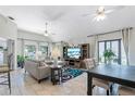 Open-concept living room features vaulted ceilings, a ceiling fan and bright, natural light at 692 Greenglen Ln, Palm Harbor, FL 34684