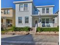 Inviting two-story home with a covered porch, manicured landscaping, and a clean, modern exterior at 7325 S Trask St, Tampa, FL 33616