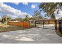 View of the front of the home with a horizontal slat fence and a concrete driveway at 934 W Wheeler Rd, Brandon, FL 33510