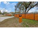 View of the horizontal slat fence and mailbox with the address of the home at 934 W Wheeler Rd, Brandon, FL 33510