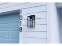 Close-up of a modern outdoor lighting fixture and home address number on the side of the home at 1018 Blakley St, Punta Gorda, FL 33980