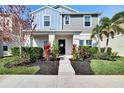 Charming two-story home with a beautifully landscaped front yard and inviting entryway at 12818 Crested Iris Way, Riverview, FL 33579