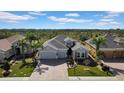 Aerial view of a well-maintained property with lush landscaping, a three-car garage, and a spacious layout at 1545 Emerald Dunes Dr, Sun City Center, FL 33573