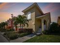 Charming home exterior with a well-manicured lawn and lush tropical landscaping at 18 Franklin S Ct # D, St Petersburg, FL 33711