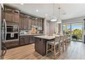 Modern kitchen with a large island, stainless steel appliances, and stylish pendant lighting at 18 Franklin S Ct # D, St Petersburg, FL 33711