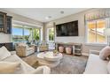 Cozy living room featuring comfortable seating, a large TV, and sliding glass doors at 18 Franklin S Ct # D, St Petersburg, FL 33711