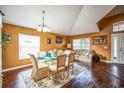 Elegant dining room with wood floors, a glass table set for six, and tasteful decor at 2340 Lawrence Hall St, Ruskin, FL 33570