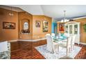 Open dining area featuring wood floors, a glass table, and a charming built-in display cabinet at 2340 Lawrence Hall St, Ruskin, FL 33570